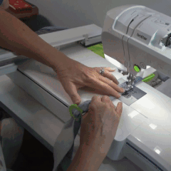 Quilter easily creating bias tape with the Rolly Sasher Collection Tool