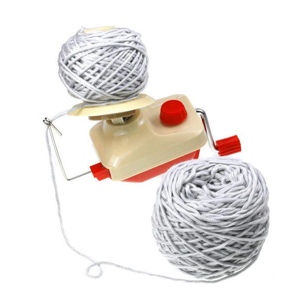 Yarn being wound neatly into a ball with the Creative Knit Yarn Ball Winder clamped to a table