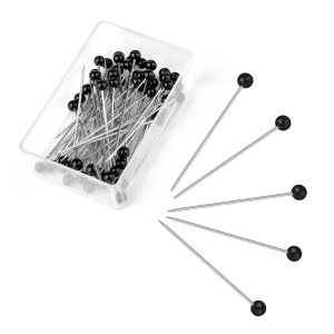 Hand picking a pin from the Straight Push Sewing Pins Kit during a craft project